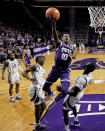 TCU guard Damion Baugh (10) shoots over Kansas State center Abayomi Iyiola, right, during the first half of an NCAA college basketball game Tuesday, Feb. 7, 2023, in Manhattan, Kan. (AP Photo/Charlie Riedel)