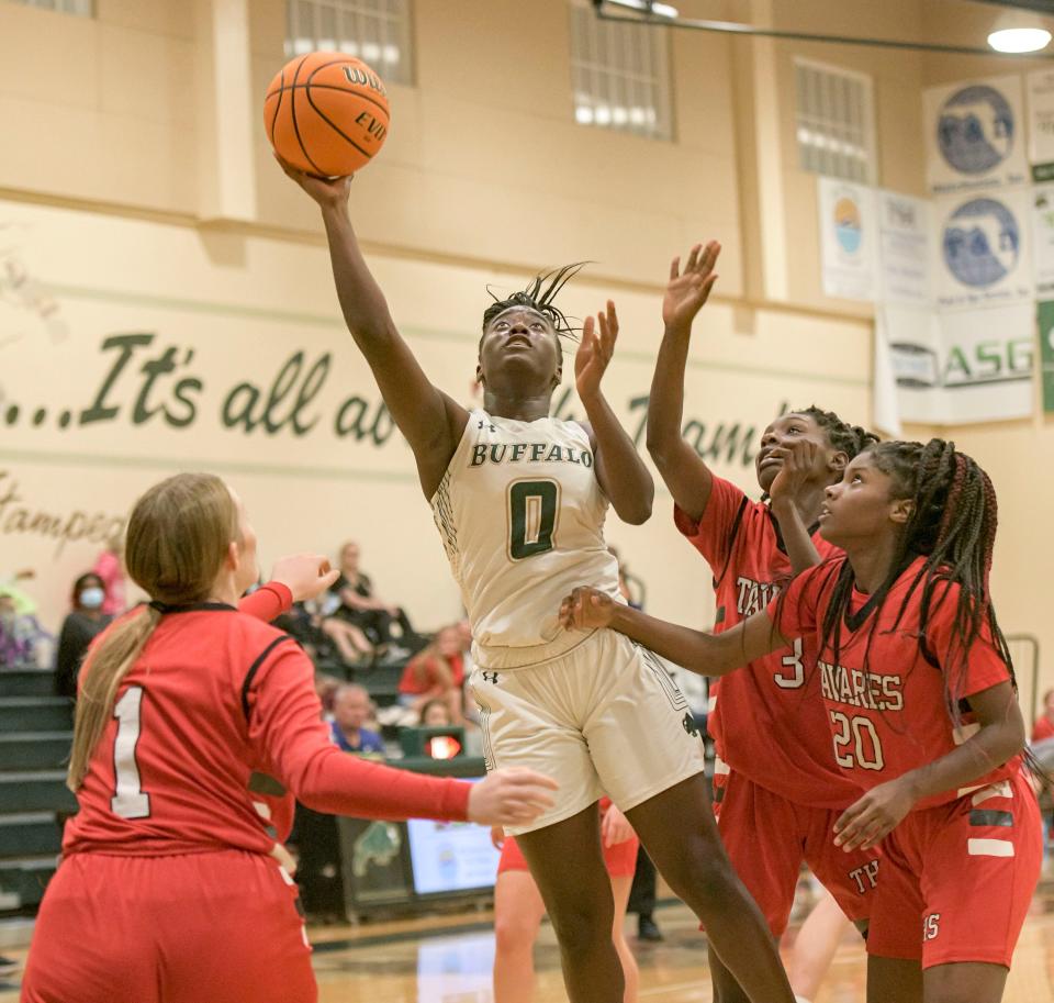 The Villages’ Essiance Jasper (0) makes a shot in traffic during Monday's game against Tavares at The Villages. Jasper scored 11 points in the Buffalo's 57-17 win. [PAUL RYAN / CORRESPONDENT]