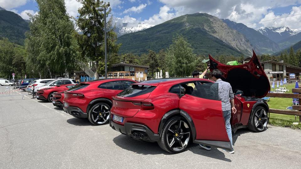 a red ferrari purosangue in a parking lot