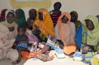 Women and children at the army headquarters in Maiduguri on July 30, 2015 after being rescued from Boko Haram camps