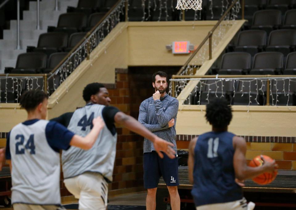 La Lumiere boys basketball head coach Pat Holmes, background, watches his team run through a drill during an open practice Thursday, Nov. 9, 2023, at the La Porte Civic Auditorium.