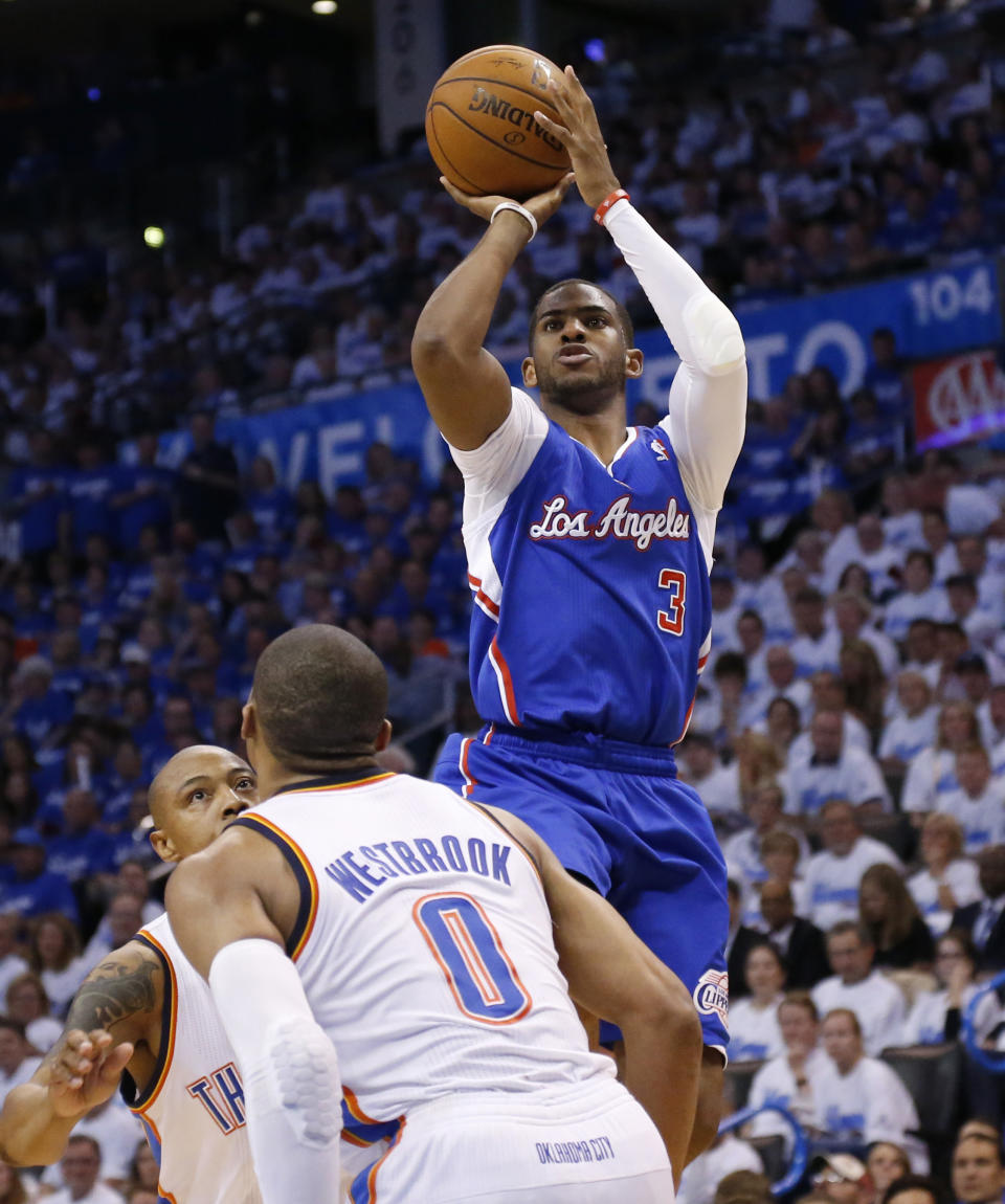 Los Angeles Clippers guard Chris Paul (3) shoots over Oklahoma City Thunder forward Caron Butler and guard Russell Westbrook (0) in the second quarter of Game 2 of the Western Conference semifinal NBA basketball playoff series in Oklahoma City, Wednesday, May 7, 2014. (AP Photo/Sue Ogrocki)