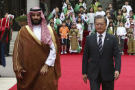South Korean President Moon Jae-In, right, and Saudi Crown Prince Mohammed bin Salman walk to view an honor guard during a welcoming ceremony at the presidential Blue House, Wednesday, June 26, 2019, in Seoul, South Korea. Bin Salman is visiting South Korea for two days - the first time by an heir to the throne of Saudi Arabia since 1998. (Chung Sung-Jun/Pool Photo via AP)