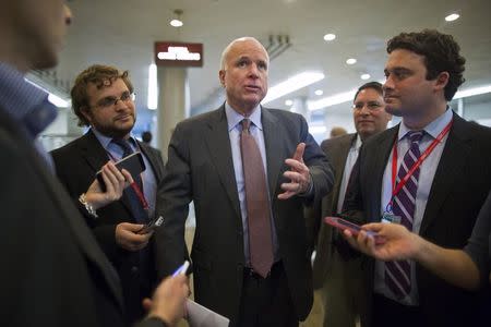 U.S. Senator John McCain (R-AZ) (C) speaks to reporters as he arrives for votes on the Senate floor at the U.S. Capitol in Washington December 12, 2014. REUTERS/Jonathan Ernst