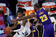 Memphis Grizzlies guard Ja Morant, left, tries to pass while under pressure from Los Angeles Lakers forward Anthony Davis, center, and forward LeBron James during the first half of an NBA basketball game Friday, Feb. 12, 2021, in Los Angeles. (AP Photo/Mark J. Terrill)