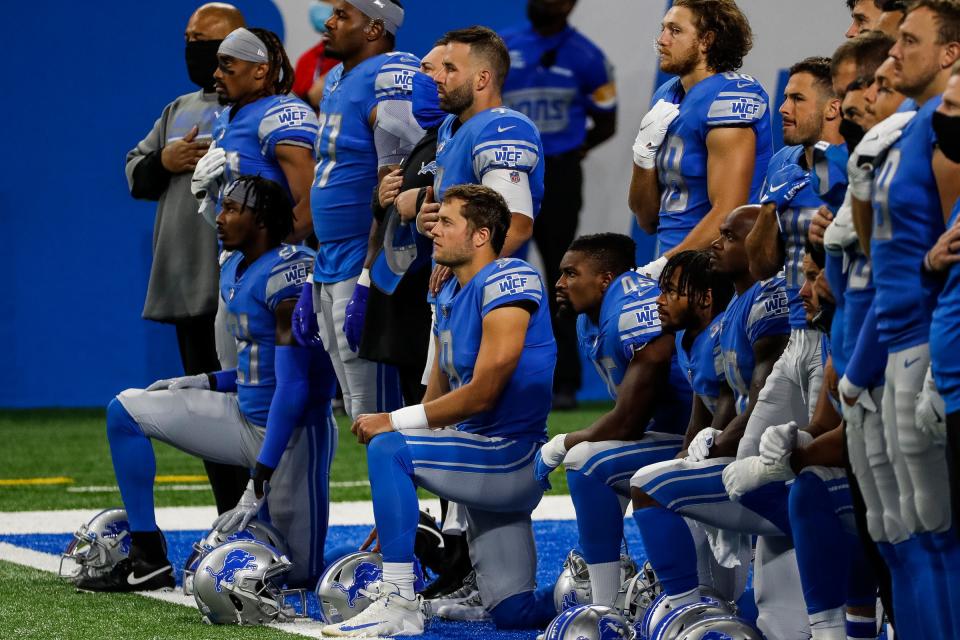 Detroit Lions players include quarterback Matthew Stafford (9) kneel during the playing of national anthem before the game against the New Orleans Saints at Ford Field in Detroit, Sunday, Oct. 4, 2020.