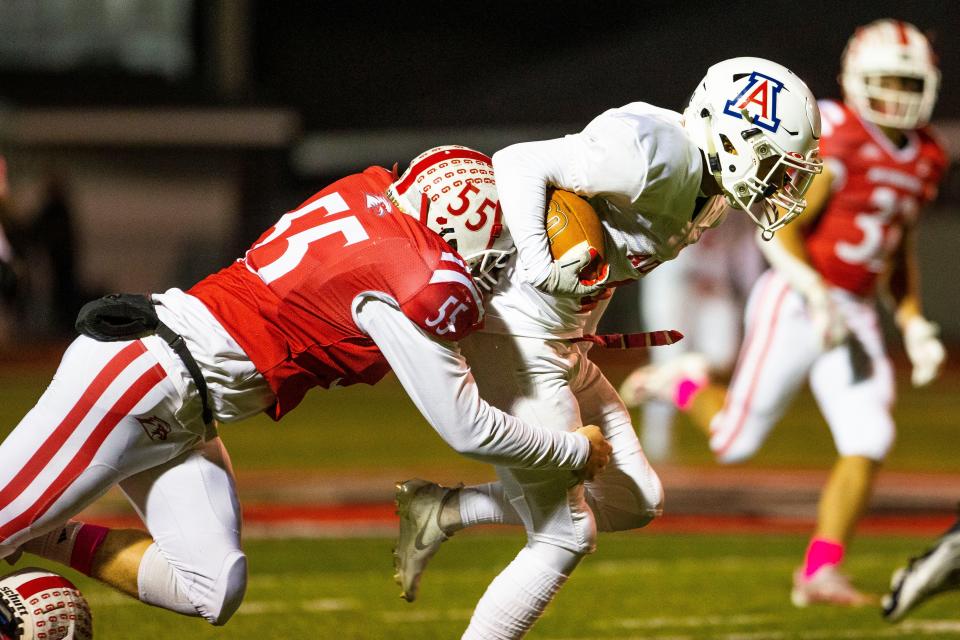 Goshen's Blake Wyman tackles Adams' Bradon Godette during the Adams vs. Goshen sectional football game Friday, Oct. 22, 2021 at Goshen High School. 