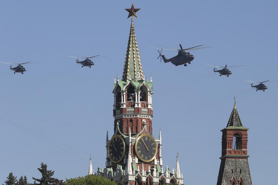 Russian Air Force helicopter Mi-26, center, with Mi-8, flies over Red Square during a Victory Day parade, which commemorates the 1945 defeat of Nazi Germany, in Moscow, Russia, Friday, May 9, 2014. Russia marked the Victory Day on May 9 holding a military parade at Red Square. (AP Photo/Denis Tyrin)