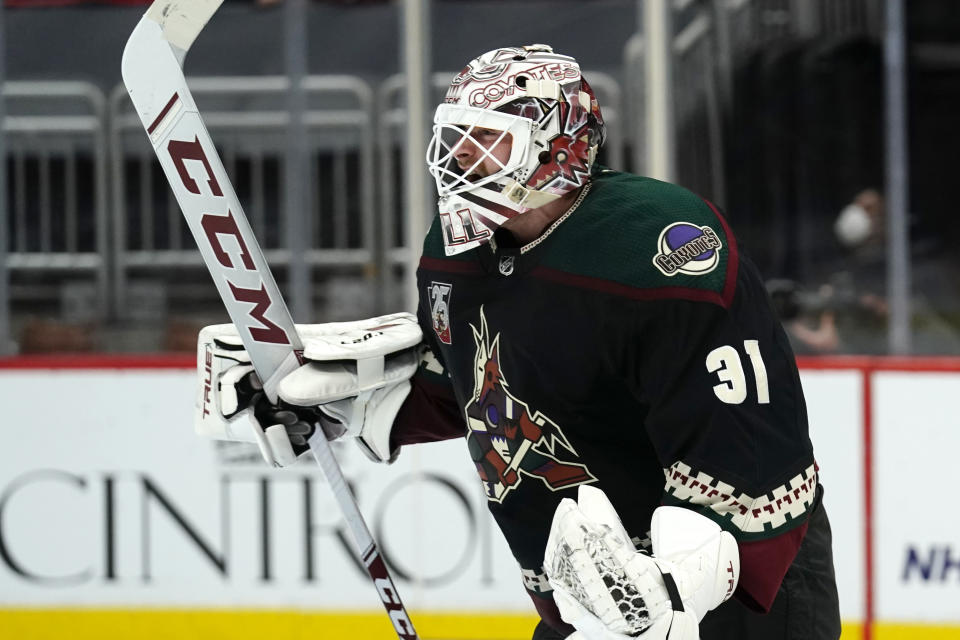 Arizona Coyotes goaltender Adin Hill reacts after the Coyotes defeated the Colorado Avalanche in a shootout in an NHL hockey game Tuesday, March 23, 2021, in Glendale, Ariz. (AP Photo/Rick Scuteri)