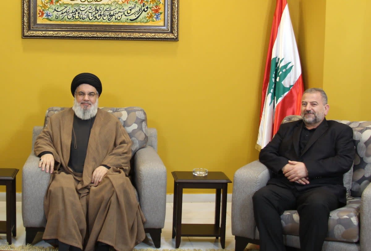 Arouri with Hezbollah leader Hassan Nasrallah (left) (Hezbollah's Media Office/AFP via)