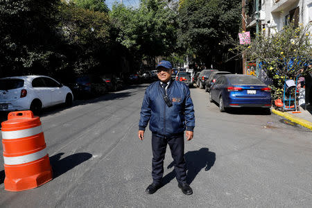 A security guard keeps watch at a street following an earthquake in Mexico City, Mexico February 1, 2019. REUTERS/Carlos Jasso