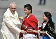 Pope Francis greets Ecuadorean natives upon arrival at the Mariscal Sucre international airport in Quito on July 5, 2015