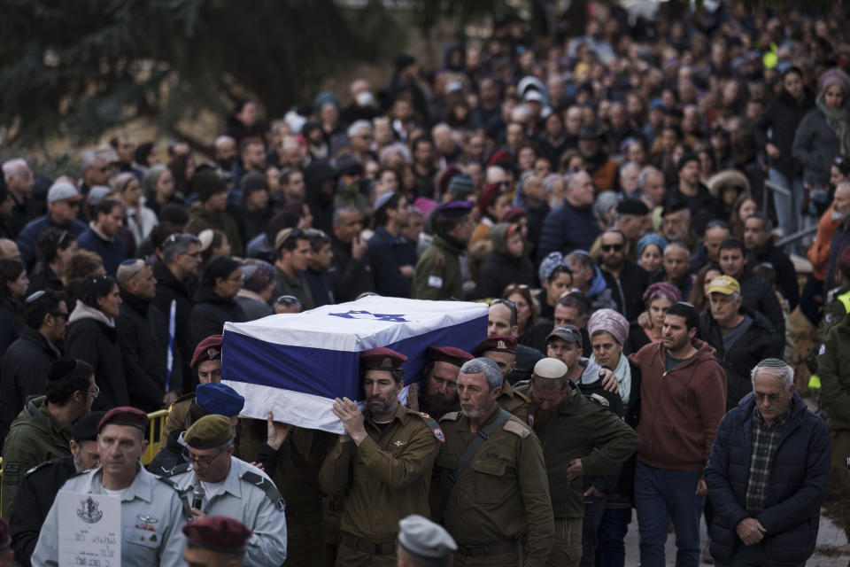 Israeli soldiers carry the flag-draped casket of reservist warrant officer Yuval Nir during his funeral at a cemetery in the West Bank settlement of Kfar Etzion, Wednesday, Jan. 31, 2024. Nir, 43, was killed during Israel's ground operation in the Gaza Strip, where the Israeli army has been battling Palestinian militants in the war ignited by Hamas' Oct. 7 attack into Israel. (AP Photo/Leo Correa)
