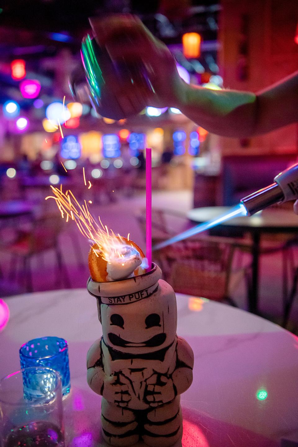 The finishing touches to the Marshmallow Man cocktail at The Tiki Easy Bar inside Hi-Wire.