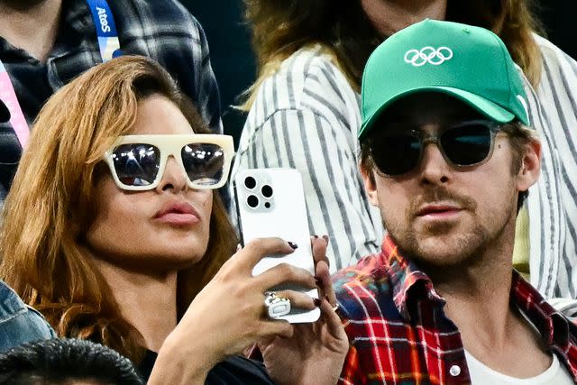 <p>LOIC VENANCE/AFP via Getty </p> Eva Mendes (L) and Ryan Gosling (R) attend the artistic gymnastics women's uneven bars final during the Paris 2024 Olympic Games at the Bercy Arena in Paris, on August 4, 2024.