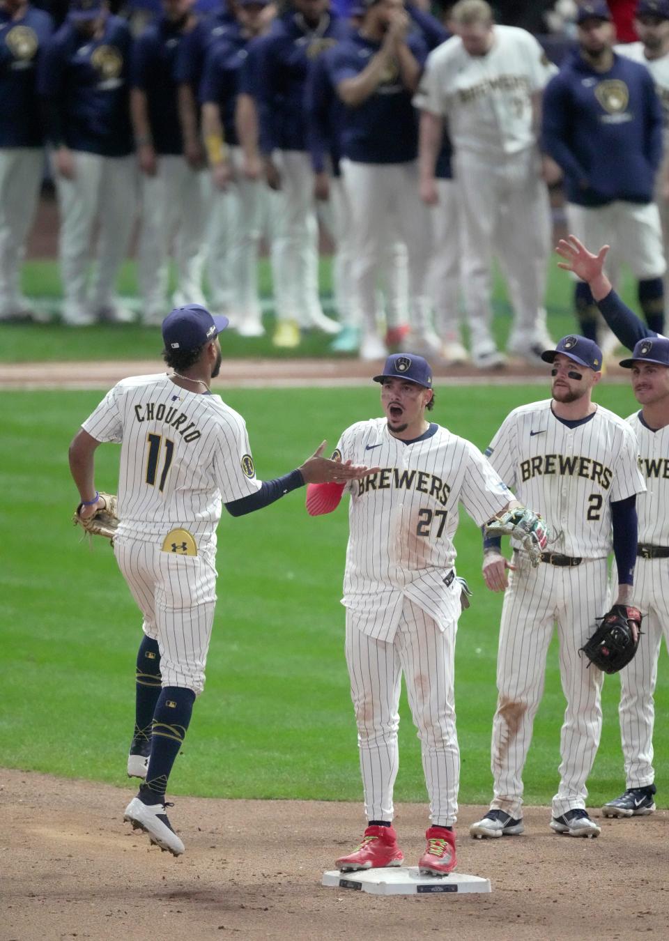 Milwaukee Brewers outfielder Jackson Chourio (11) and shortstop Willy Adames (27) celebrate after their 5-3 wild-card playoff win over the New York Mets on Wednesday at American Family Field in Milwaukee.