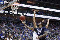 Xavier's Naji Marshall (13) attempts a layup as Seton Hall's Jared Rhoden (14) defends during the first half of an NCAA college basketball game, Saturday, feb. 1, 2020, in Newark, N.J. (AP Photo/Michael Owens)