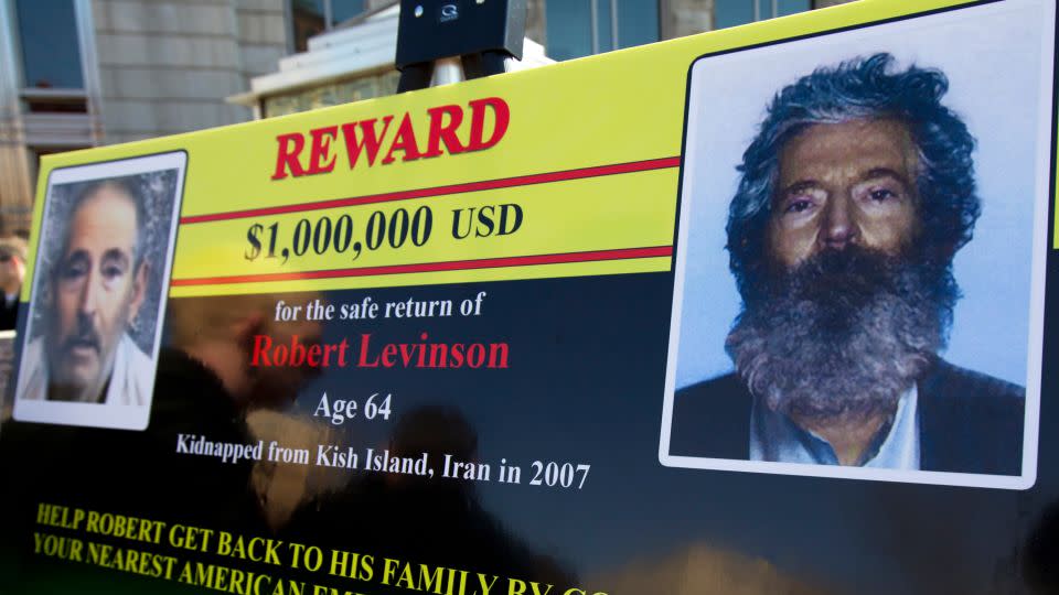 An FBI poster shows a photo of Levinson taken from captors' video and a composite image of how he would have looked in 2012, five years into captivity. His family learned of his death in 2020. - Manuel Balce Ceneta/AP