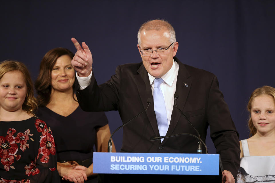 Australian Prime Minister Scott Morrison speaks to party supporters flanked by his wife, Jenny, second left, and daughters Lily, right, and Abbey, after his opponent conceded in the federal election in Sydney, Australia, Sunday, May 19, 2019. Australia's ruling conservative coalition, lead by Morrison, won a surprise victory in the country's general election, defying opinion polls that had tipped the center-left opposition party to oust it from power and promising an end to the revolving door of national leaders. (AP Photo/Rick Rycroft)