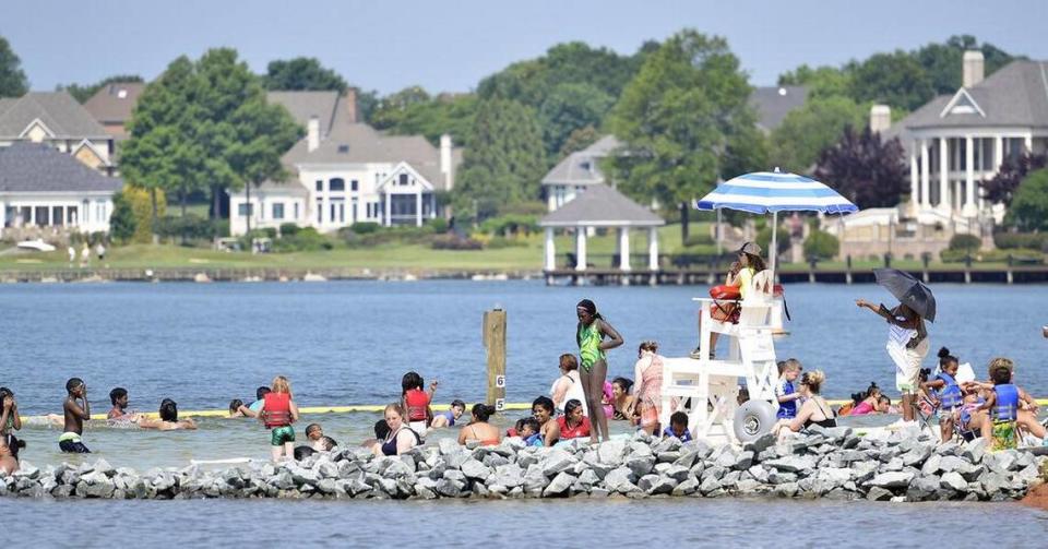 Families enjoy Ramsey Creek beach on Lake Norman in this 2017 Charlotte Observer file photo. Mecklenburg County will open the beach with “limited capacity” from noon to 5 p.m. on Saturday and Sunday, July 3 and 4, 2021
