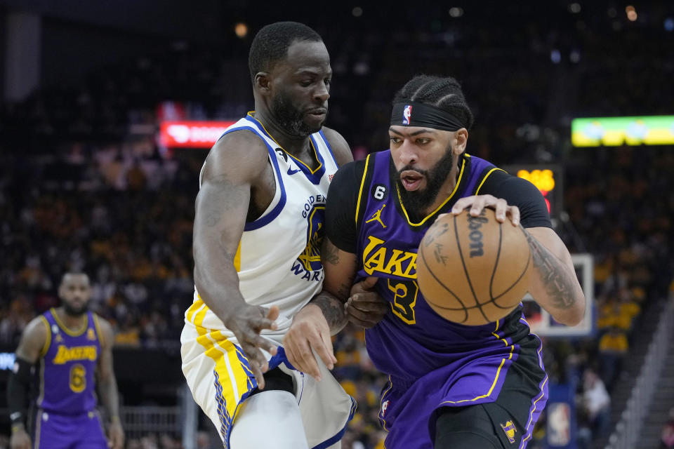 Los Angeles Lakers forward Anthony Davis, right, works toward the basket against Golden State Warriors forward Draymond Green during the first half of Game 2 of an NBA basketball Western Conference semifinal game, Thursday, May 4, 2023, in San Francisco. (AP Photo/Godofredo A. Vásquez)