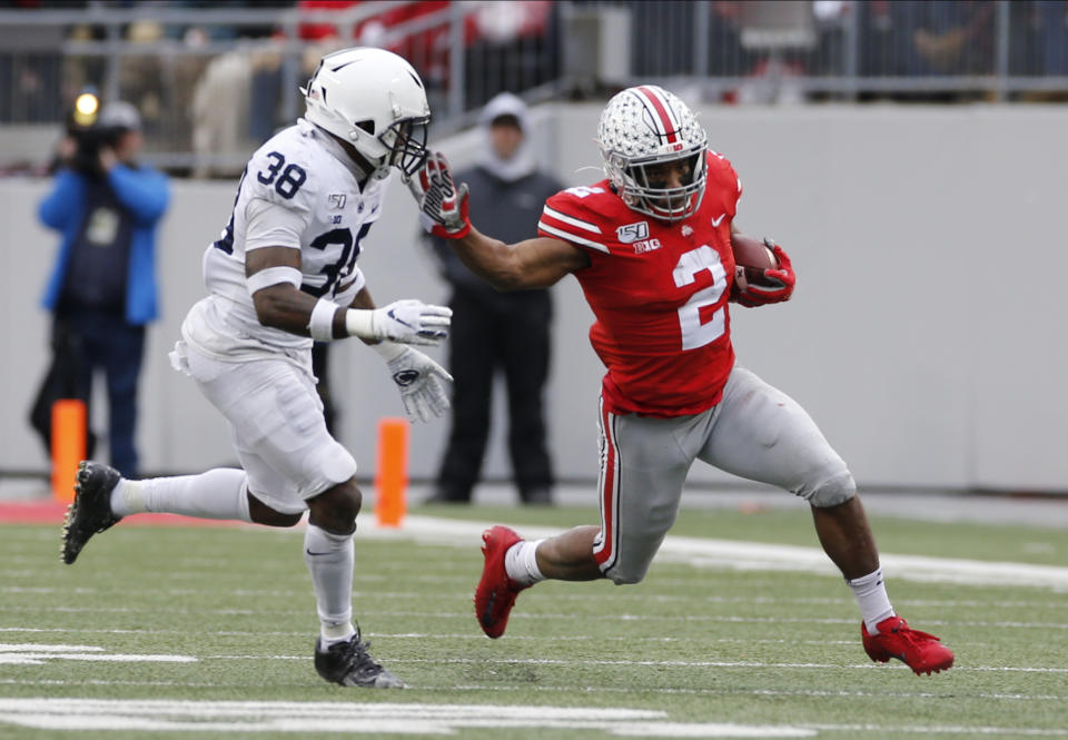 Ohio State running back J.K. Dobbins, right, cuts up field against Penn State defensive back Lamont Wade during the first half of an NCAA college football game Saturday, Nov. 23, 2019, in Columbus, Ohio. (AP Photo/Jay LaPrete)