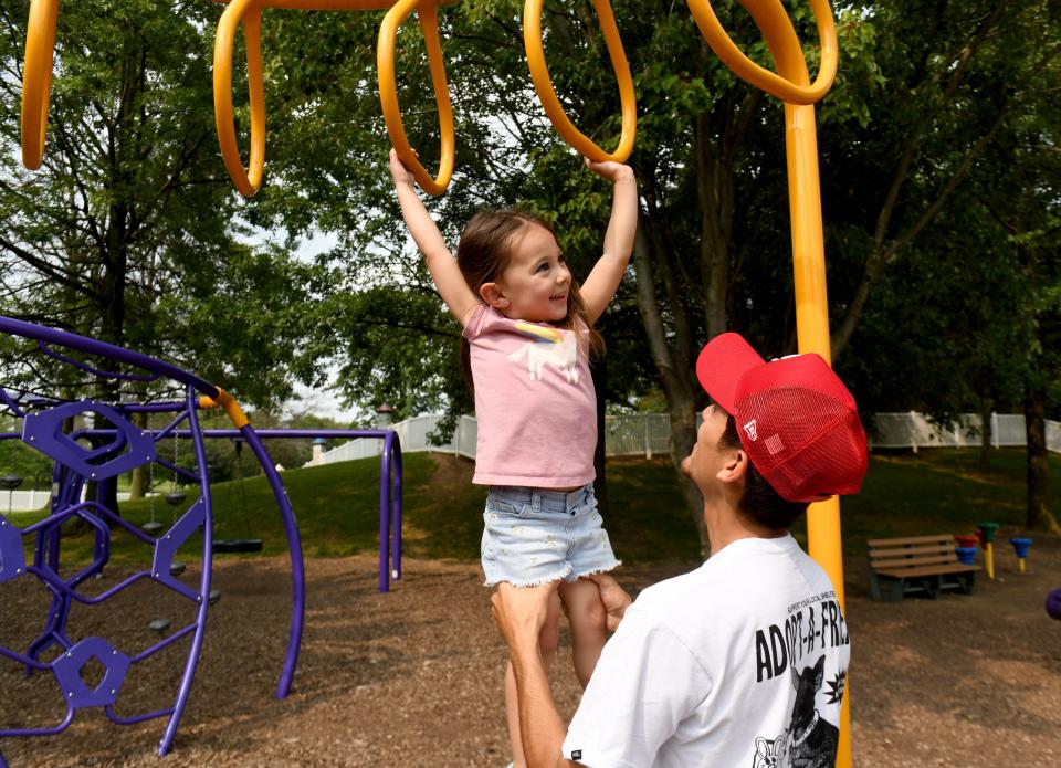 Valentina Carbajal, 3, of Massillon gets a hand from her father, Marco Carbajal, during an outing at North Park in Jackson Township.