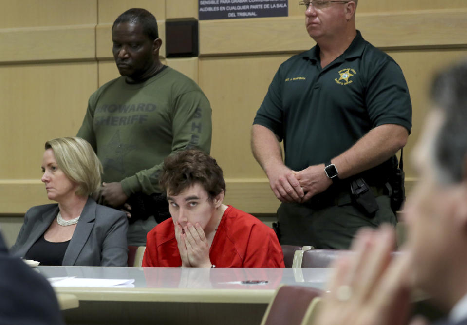 Parkland school shooting suspect Nikolas Cruz sits in court at the Broward Courthouse in Fort Lauderdale, Fla., Wednesday May 1, 2019 for a motion by the Public Defender's Office to withdraw from the case due to Cruz receiving an inheritance that can be used to pay for a private attorney. Defense attorney Melisa McNeill and Diane Cuddihy sit with their client. Nikolas Cruz, who faces the death penalty if convicted. Cruz is accused of killing 17 and wounding 17 in the February 2018 mass shooting at Marjory Stoneman Douglas High School in Parkland, Fla. (Mike Stocker/South Florida Sun-Sentinel via AP, Pool)\