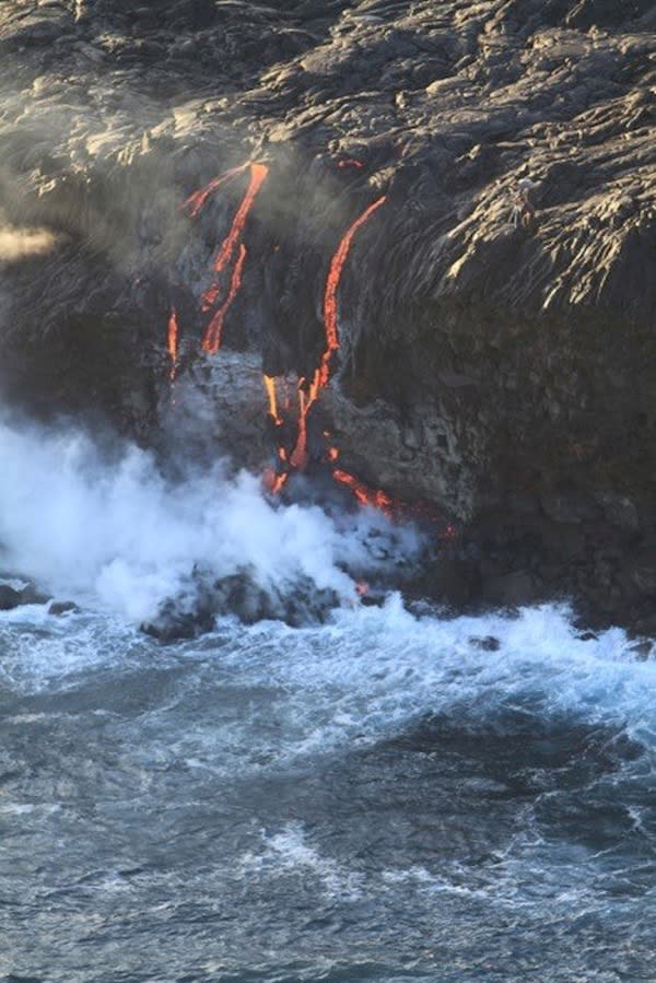 Lava overtopped a seaside cliff in Hawaii on Nov. 24, sending up steam plumes.