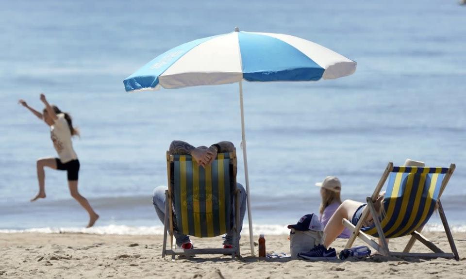People enjoy the warm weather on Bournemouth beach (Andrew Matthews/PA) (PA Wire)