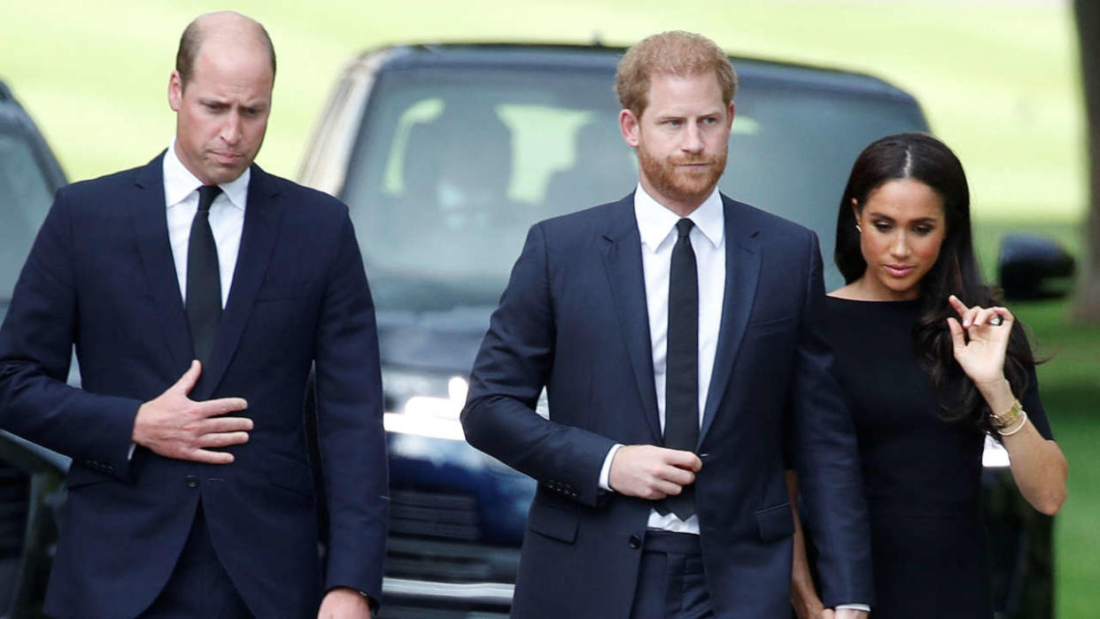 Britain's William, Prince of Wales, Prince Harry and Meghan, the Duchess of Sussex, walk outside Windsor Castle, following the passing of Britain's Queen Elizabeth, in Windsor, Britain, September 10, 2022. REUTERS/Peter Nicholls