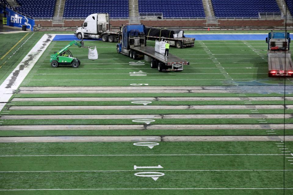Work begins on the field at Ford Field in Detroit on Thursday, Jan. 26, 2023. The Lions are making the switch from a slit-film turf to a monofilament field turf, which is the most grass-like surface of the turf that is used in NFL stadiums.