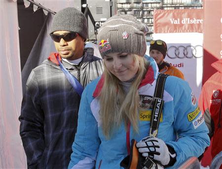 Lindsey Vonn (front R) of the U.S. and her boyfriend, golfer Tiger Woods leave after the Women's World Cup Downhill skiing race in Val d'Isere, French Alps, December 21, 2013. REUTERS/Robert Pratta