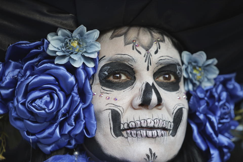 A woman dressed as a "Catrina" parades down Mexico City's iconic Reforma avenue during celebrations ahead of the Day of the Dead in Mexico, Sunday, Oct. 22, 2023. (AP Photo/Ginnette Riquelme)