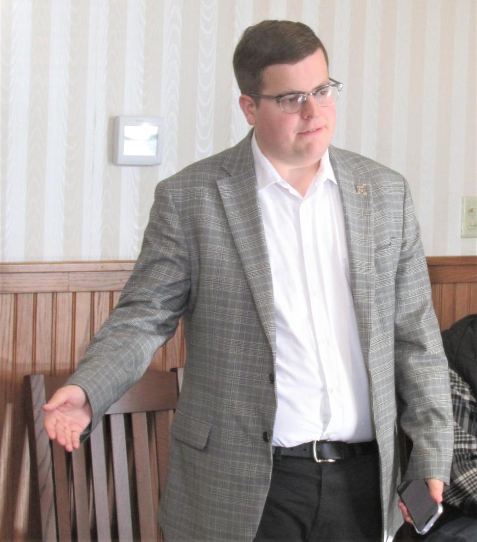 Cody Pettit, a representative of the Ohio Treasurer's Office, addresses Holmes County commissioners at Monday's meeting.