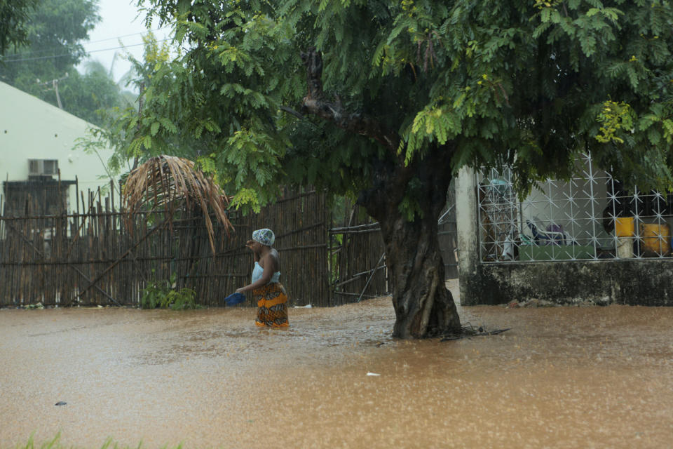 A woman walks through rising waters in Natite neighbourhood, in Pemba city on the northeastern coast of Mozambique, Sunday, April, 28, 2019. Serious flooding began on Sunday in parts of northern Mozambique that were hit by Cyclone Kenneth three days ago, with waters waist-high in areas, after the government urged many people to immediately seek higher ground. Hundreds of thousands of people were at risk. (AP Photo/Tsvangirayi Mukwazhi)