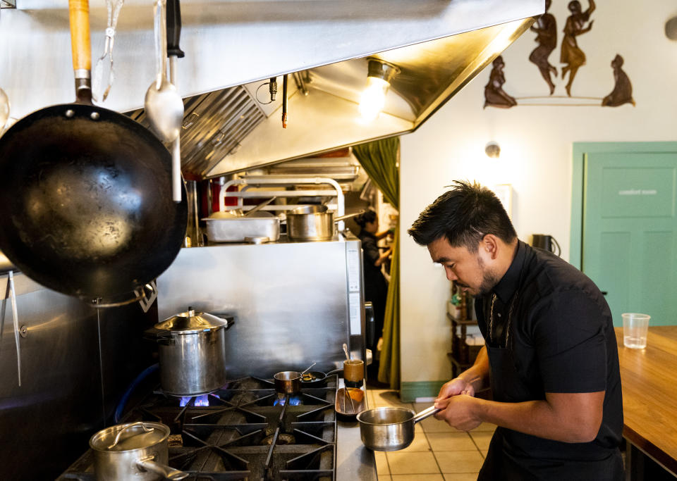 Chef Aaron Verzosa of Filipino American restaurant Archipelago prepares Anak ni Bet, his version of pinakbet, or vegetables in shrimp sauce, Wednesday, May 24, 2023, in Seattle. Verzosa is nominated for a 2023 James Beard Award in the Best Chef: Northwest and Pacific category. (AP Photo/Lindsey Wasson)