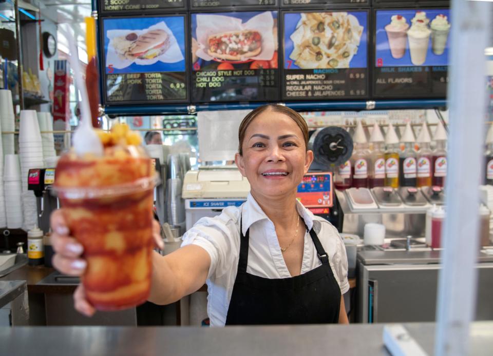 Serry Som serves up a mangonada  at Gleason's Ice Cream located on Sierra Nevada and Fremont streets in Stockton on Jul. 12. 2023.