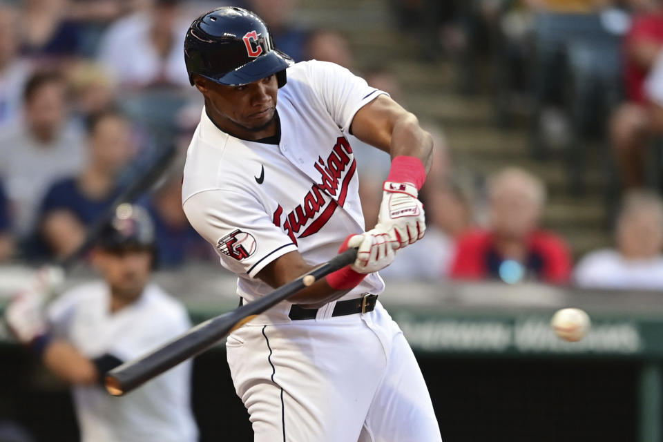 Cleveland Guardians' Oscar Gonzalez singles during the fourth inning of the team's baseball game against the Arizona Diamondbacks, Tuesday, Aug. 2, 2022, in Cleveland. (AP Photo/David Dermer)