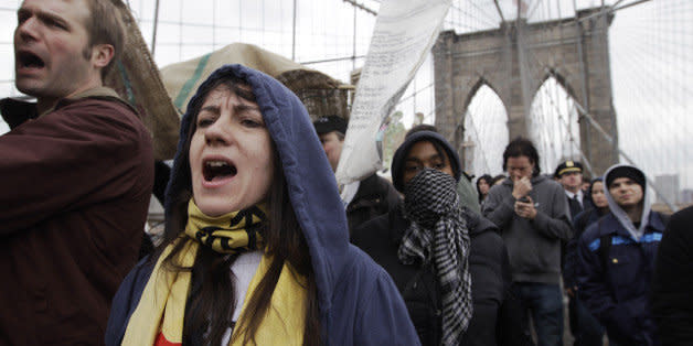 Occupy Wall Street activists march over the Brooklyn Bridge, Sunday, April 1, 2012 in New York. The protestors marched across the Brooklyn Bridge to mark six months since hundreds of them were arrested on the bridge. (AP Photo/Mary Altaffer) (Photo: )