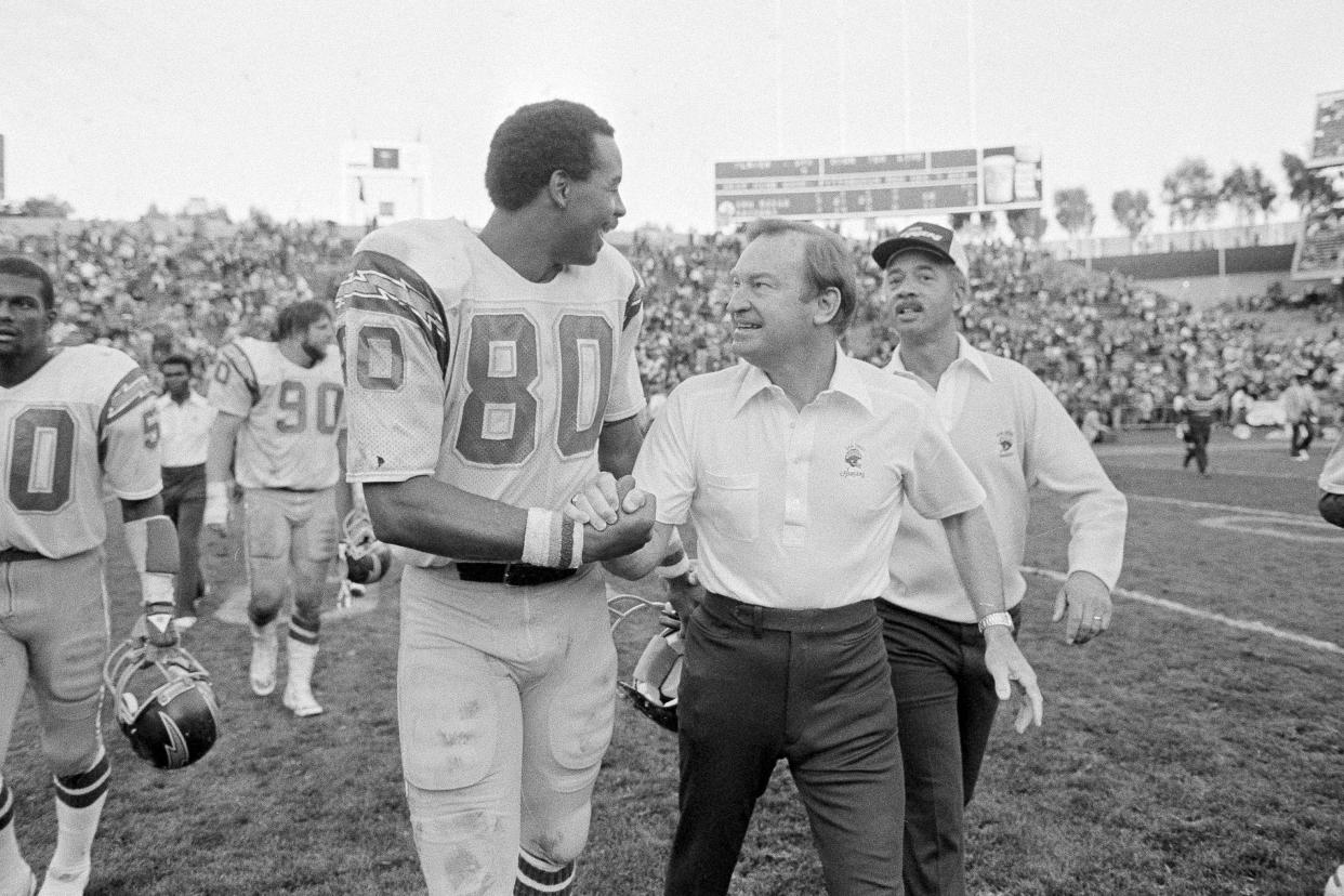 San Diego Chargers head coach Don Coryell, walking off the field with tight end Kellen Winslow (80) after a win over the Raiders in 1981, will be inducted to the Pro Football Hall of Fame. (AP Photo/Paul Sakuma, File)
