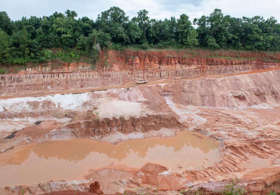 Jeff Ates IV drives to the bottom of a borrow pit on his property in Milton on Wednesday. The city of Milton is considering using it as a temporary Rapid Infiltration Basin (RIB) to help with wastewater alleviation. The city would need to strike a deal with the company currently under lease with the property North American IPS, in order to use the land.