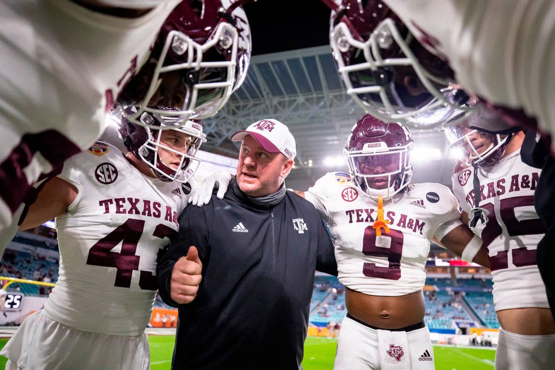 Texas A&M defensive coordinator Mike Elko talks to his players before the Capital One Orange Bowl game against North Carolina at Hard Rock Stadium in Coral Gables, FL. Jan. 2, 2021.