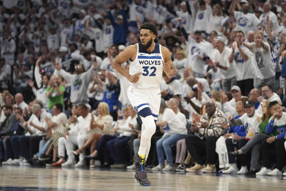 Minnesota Timberwolves center Karl-Anthony Towns (32) jogs downcourt after making a 3-point basket during the first half of Game 3 of an NBA basketball second-round playoff series against the Denver Nuggets, Friday, May 10, 2024, in Minneapolis. (AP Photo/Abbie Parr)