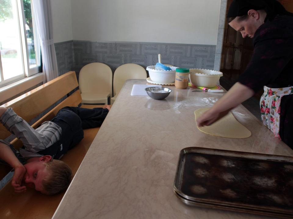 A mother and son making cookies in preparation for Sunday lunch after church in the Mennonite colony of Manitoba, Bolivia.