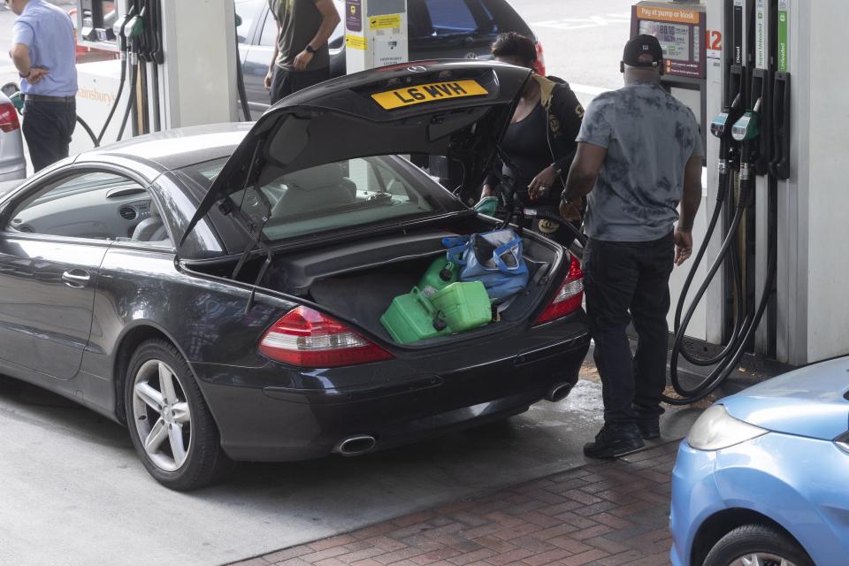 Motorists fill up their vehicleâs with fuel at a Sainsbury's supermarket petrol station in North West London