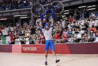 <p>IZU, JAPAN - AUGUST 04: Filippo Ganna of Team Italy lifts his bike to celebrates winning a gold medal after setting a new World record during the Men's team pursuit finals, gold medal of the track cycling on day twelve of the Tokyo 2020 Olympic Games at Izu Velodrome on August 04, 2021 in Izu, Japan. (Photo by Justin Setterfield/Getty Images)</p> 