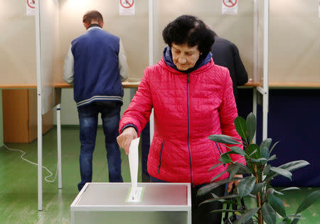A woman casts her vote during the first round of Lithuanian Presidential election in Vilnius, Lithuania May 12, 2019. REUTERS/Ints Kalnins