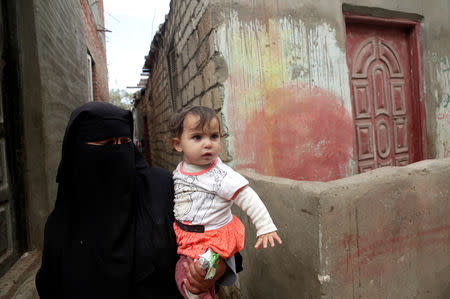 Abeer, 39 years old, holds her daughter in Egypt's Nile Delta village of El Shakhluba, in the province of Kafr el-Sheikh, Egypt May 5, 2019. Picture taken May 5, 2019. REUTERS/Hayam Adel