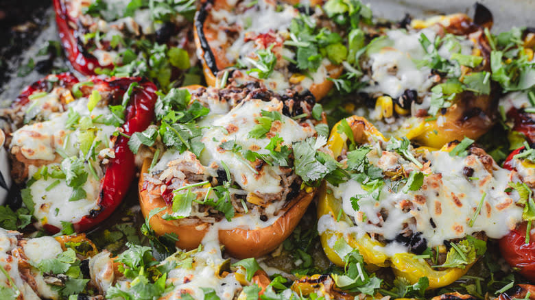 southwest turkey and cheese stuffed peppers on baking sheet